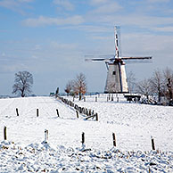 Windmill Ter Hengst in the snow in winter landscape in the Flemish Ardennes near Ronse, Belgium
