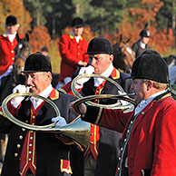 Huntsmen blowing hunting horns at drag hunting demonstration in Belgium 