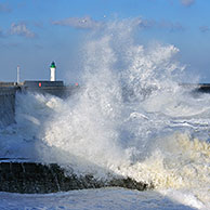 Waves crashing into jetty during storm at Saint-Valéry-en-Caux, Normandy, France