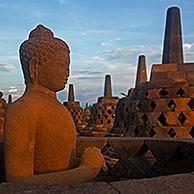 Buddha statue and stupas at Borobudur / Barabudur, 9th-century Mahayana Buddhist Temple in Magelang, Central Java, Indonesia