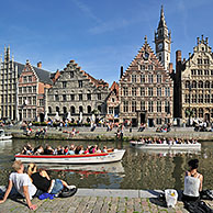 Tourists on quay along the river Lys with view over the Graslei / Grass Lane at Ghent, Belgium