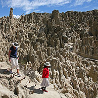 Tourists visiting the eroded limestone rock formations in the Valley of the Moon / Valle de la Luna near La Paz, Bolivia