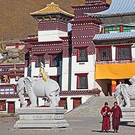 Two monks in front of Tibetan monastery Sershu Dzong in the village Sershu / Serxu, Sichuan Province, China