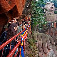 Queue of Chinese tourists walking down the stairs to see the Leshan Giant Buddha, largest stone-carved buddha statue in the world from the Tang Dynasty at Leshan, Sichuan province, China