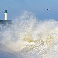 Waves crashing into jetty during storm at Saint-Valéry-en-Caux, Normandy, France
