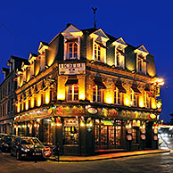 Illuminated façade of hotel at night at Etretat, Normandy, France