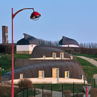 Camping site with quilles en l'air, once homes for the poorest families, made of upturned fishing boats at Equihen-Plage, Côte d'Opale / Opal Coast, France
