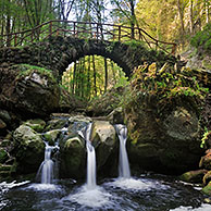 Cascade and old bridge Schiessentümpel over the Black Ernz in Little Switzerland  / Mullerthal, Grand Duchy of Luxembourg