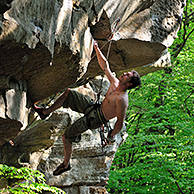 Rock climber climbing in sandstone cliff Wanterbaach at Berdorf, Little Switzerland  / Mullerthal, Grand Duchy of Luxembourg