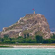 The Fortress of Van / Van Citadel / Van Kalesi on the shores of Lake Van during thunderstorm, Turkey