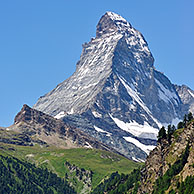 View over the Matterhorn mountain with alpine meadows and pine forests in the Swiss Alps, Valais, Switzerland
