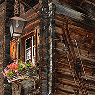 Housefront of traditional wooden house decorated with old skis in the Alpine village Grimentz, Valais, Switzerland
