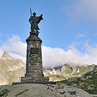 The statue of Saint Bernard in the mist at the Great Saint Bernard Pass in the Swiss Alps, Switzerland